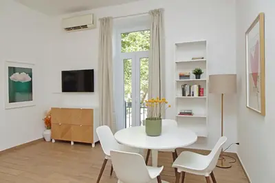 a white dining room with a white table and chairs at Doria in Rome