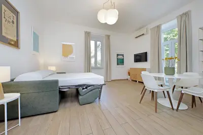 a bedroom with a bed and a table and chairs at Doria in Rome