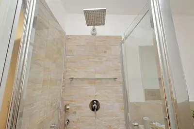 a bathroom with a shower with a glass door at Doria in Rome