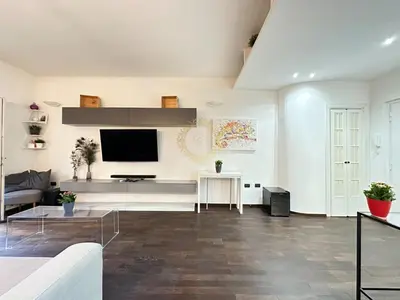 a living room with a couch and a tv at Casa Vacanze Secret Garden in Rome