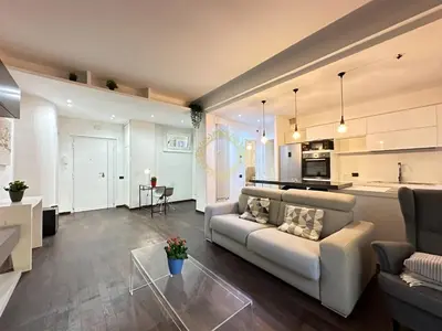 a living room with a couch and a kitchen at Casa Vacanze Secret Garden in Rome