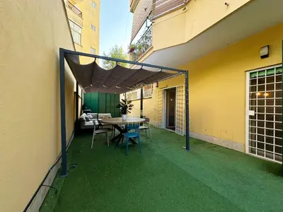 a patio with a table and chairs on the side of a building at Casa Vacanze Secret Garden in Rome