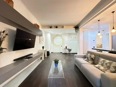 a living room with a couch and a tv at Casa Vacanze Secret Garden in Rome