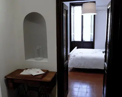 a bedroom with a bed and a table with a table sidx sidx sidx at Borgo Pio Holiday in Rome