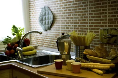 a kitchen counter with a sink and a counter top with food at Borgo Pio Holiday in Rome