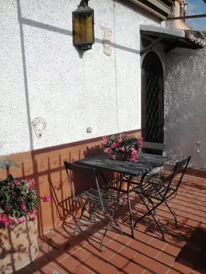 a table and chairs on a patio with flowers at Borgo Pio Holiday in Rome