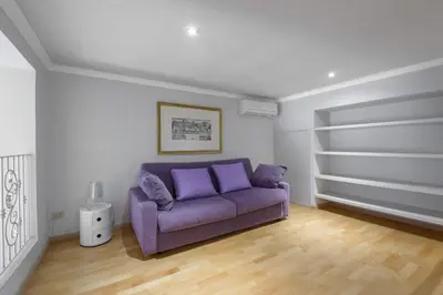 a living room with a purple couch in a room at Navona New Deluxe Apartment in Rome