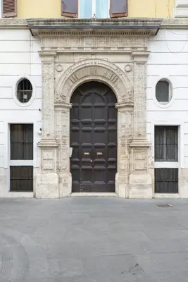 a large black door on a white building at Navona New Deluxe Apartment in Rome