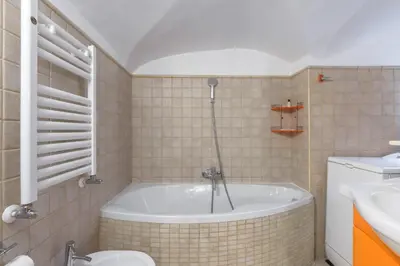 a bathroom with a tub and a toilet and a sink at Navona New Deluxe Apartment in Rome