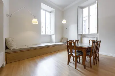 a dining room with a couch and a table and chairs at Navona New Exclusive Apartment in Rome
