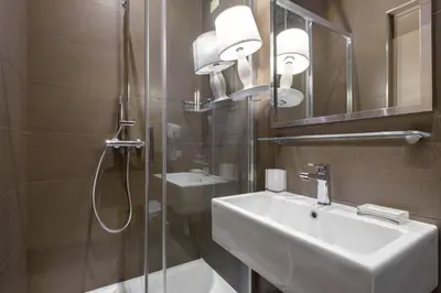 a bathroom with a sink and a shower and a mirror at Navona New Exclusive Apartment in Rome