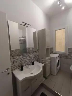 a white bathroom with a sink and a toilet at New and beautiful house in the heart of Rome in Rome