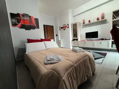 a bedroom with a large bed with red pillows on it at New and beautiful house in the heart of Rome in Rome