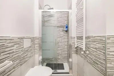 a white bathroom with a toilet and a shower at New and beautiful house in the heart of Rome in Rome