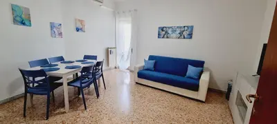 a dining room with a blue couch and a table and chairs at Barbara Sweet Home - Appartamento Intero in Rome