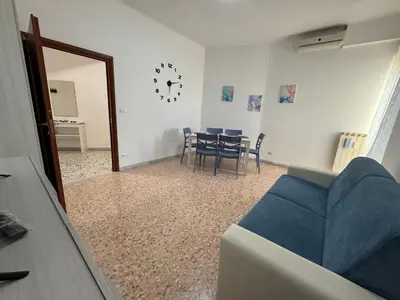 a living room with a blue couch and a table at Barbara Sweet Home - Appartamento Intero in Rome