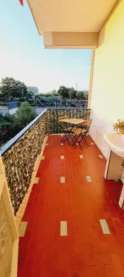 a balcony with a table and chairs on a ledge at Barbara Sweet Home - Appartamento Intero in Rome