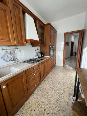 a kitchen with wooden cabinets and a sink at Barbara Sweet Home - Appartamento Intero in Rome