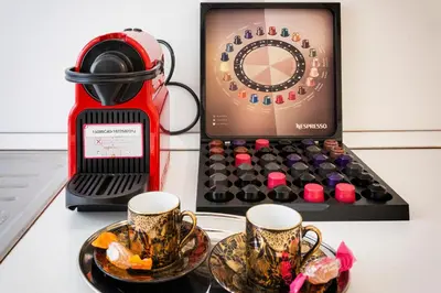 a table with two cups of coffee and a blender at Aurora Guest House in Rome