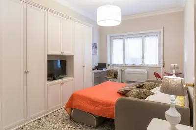 a bedroom with a bed and a flat screen tv at Aurora Guest House in Rome