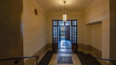 an empty hallway with a large glass door and a hallway at EasyTopStay - Campo de' Fiori Pinky House in Rome
