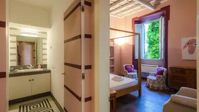 a bathroom with a sink and a bed in a room at EasyTopStay - Campo de' Fiori Pinky House in Rome