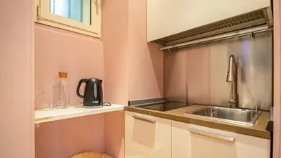 a small kitchen with a sink and a microwave at EasyTopStay - Campo de' Fiori Pinky House in Rome