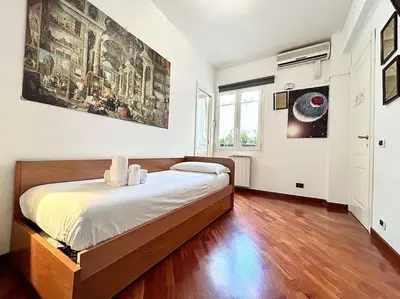 a bedroom with a large bed in a room at Room Ostiense in Rome