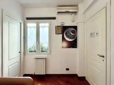 a room with a window and a picture of a galaxy at Room Ostiense in Rome
