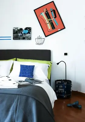 a bedroom with a bed and a picture on the wall at Milvio22 Apartment in Rome