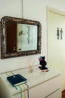 a mirror on top of a dresser in a room at Milvio22 Apartment in Rome