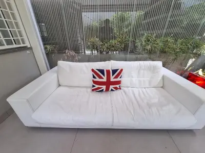 a white couch with a pillow on a balcony at Brando Apartment II in Rome