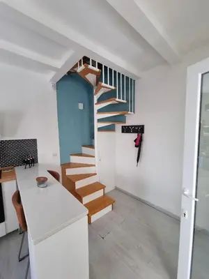 a staircase in a home with white walls and wooden stairs at Brando Apartment II in Rome
