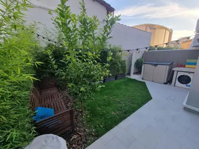 a small garden with a bench in a yard at Brando Apartment II in Rome