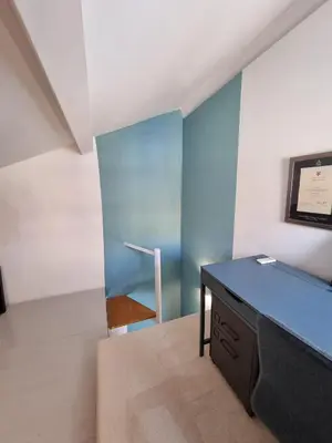 a room with a desk and a blue wall at Brando Apartment II in Rome
