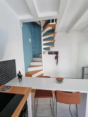 a kitchen with a spiral staircase in the background at Brando Apartment II in Rome