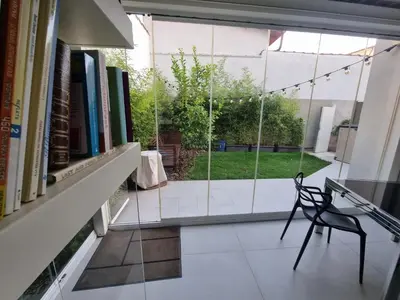 a chair sitting in a room with a window at Brando Apartment II in Rome