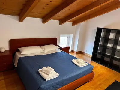 a bedroom with a bed with two towels on it at Casa Marlon Pietralata in Rome