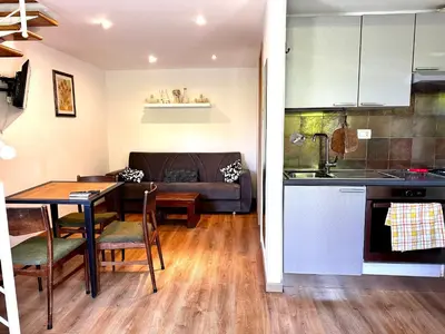 a kitchen and living room with a table and a couch at Casa Marlon Pietralata in Rome