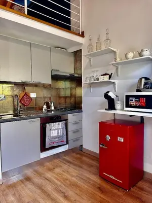 a kitchen with a red appliance in a room at Casa Marlon Pietralata in Rome