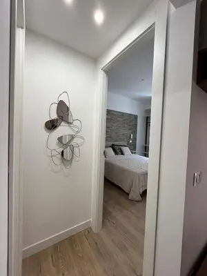 a white room with a bed and a mirror at dAngelo Apartment Vatican Rome in Rome