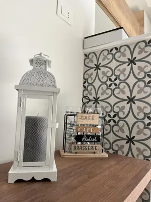 a lantern sitting on top of a table with books at dAngelo Apartment Vatican Rome in Rome