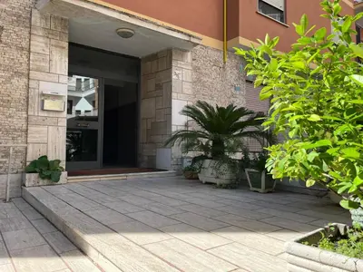 a building with a courtyard with a potted plant at dAngelo Apartment Vatican Rome in Rome