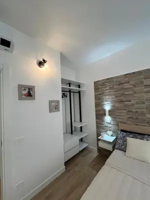 a bedroom with a bed and a brick wall at dAngelo Apartment Vatican Rome in Rome