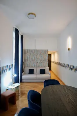 a living room with a white couch and a table at Livia86 - Trastevere in Rome