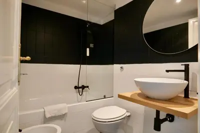 a bathroom with a sink and a toilet and a tub at Livia86 - Trastevere in Rome
