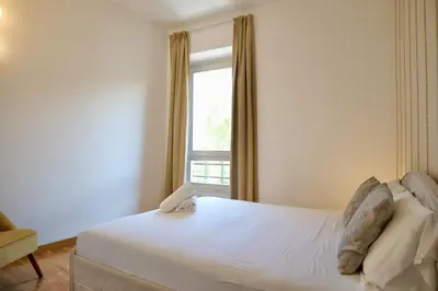 a bedroom with a white bed and a window at Livia86 - Trastevere in Rome