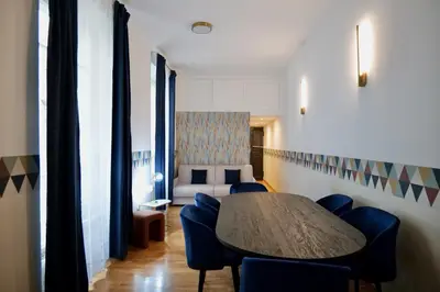 a room with a table and chairs and a couch at Livia86 - Trastevere in Rome