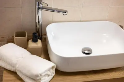 a bathroom with a white sink and a towel at La Bellavita Trastevere in Rome