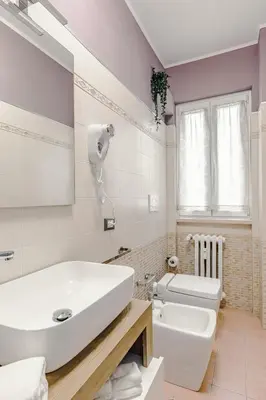 a bathroom with a white sink and a toilet at La Bellavita Trastevere in Rome